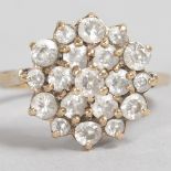 A 9CT YELLOW GOLD DIAMOND FLOWER HEAD CLUSTER RING.