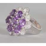 A SILVER, TANZANITE AND BRILLIANT SET CLUSTER RING.