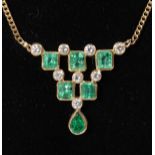 A 9CT YELLOW GOLD, DIAMOND AND EMERALD PENDANT ON CHAIN.