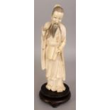 AN EARLY 20TH CENTURY CHINESE CARVED IVORY FIGURE OF A BEARDED IMMORTAL, together with a fitted