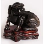 A GOOD 19TH CENTURY CHINESE SMOKY QUARTZ CARVING OF A BUDDHISTIC LION, together with a fitted wood