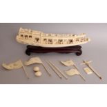 AN EARLY 20TH CENTURY CHINESE CARVED IVORY MODEL OF A RIVER BOAT, together with a fitted wood