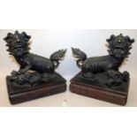 A GOOD PAIR OF CHINESE BRONZE MODELS OF BUDDHISTIC LIONS, together with fitted wood stands, each