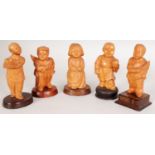 A GROUP OF FIVE CHINESE COMMUNIST PERIOD CARVED WOOD FIGURES OF CHILDREN, each mounted on a fixed