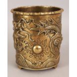 AN EARLY 20TH CENTURY CHINESE POLISHED BRONZE BRUSHPOT, cast in relief with a dragon pursuing a