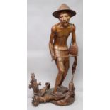 A VERY LARGE LIFE SIZE SOUTH-EAST ASIAN CARVED WOOD FIGURE OF A FISHERMAN, clad in a loin cloth