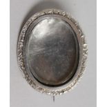 A SILVER OVAL MINIATURE FRAME BROOCH.