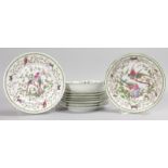 A SET OF EIGHT FRENCH PORCELAIN PLATES and TWO BOWLS painted with brilliant coloured birds (10).