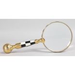 A MAGNIFYING GLASS with black and white handle.