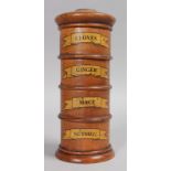 A FOUR TIER CIRCULAR SPICE TOWER, cloves, ginger, mace and nutmeg. 7ins high.