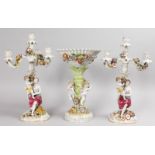 A CONTINENTAL PORCELAIN GARNITURE "SCHIERHOLZ" of a pair of three branch candelabra with classical