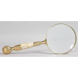A MAGNIFYING GLASS with mother-of-pearl handle.