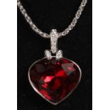 A SWAROVSKI RED STONE PENDANT AND CHAIN.