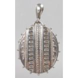 AN INDIAN SILVER OVAL LOCKET.