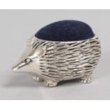 A NOVELTY SILVER HEDGEHOG PIN CUSHION.