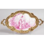 A 19TH CENTURY FRENCH SHAPED FAMILLE ROSE DISH with ormolu mounts and handles, painted with a