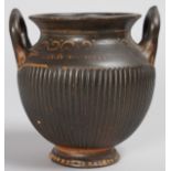 A SMALL GREEN 200BC TWO HANDLED FLUTED URN SHAPED VASE, found in 1852. 4.75ins high.