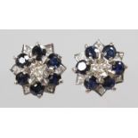 A PAIR OF 18CT WHITE GOLD, SAPPHIRE AND DIAMOND FLOWER SHAPED EARRINGS.