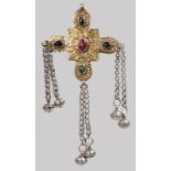 AN ISLAMIC SILVER CROSS set with stones, six bells on chain.