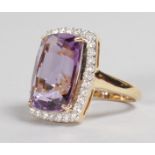A SUPERB 18CT YELLOW GOLD SUBSTANTIAL AMETHYST of 10CTS, surrounded by approx. a carat of diamonds.