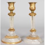 A GOOD PAIR OF ROCK CRYSTAL AND ORMOLU CANDLESTICKS on circular bases. 7.75ins high.