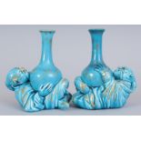 A PAIR OF MINTON PALE BLUE VASES, as a Chinese man on his back holding a vase with gilt