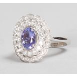 A GOOD 18CT WHITE GOLD, TANZANITE AND DIAMOND CLUSTER RING.