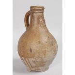 A GOOD 16TH-17TH CENTURY BELLARMINE STONEWARE JUG with stylised bearded mans face and oval crest.