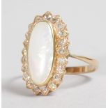 A YELLOW GOLD, OPAL AND DIAMOND RING with large opal surrounded by diamonds.