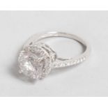 A SUPERB 18CT WHITE GOLD DIAMOND BASKET SET RING, surrounded by diamonds with diamond shoulders, 3CT