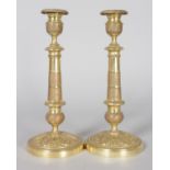 A GOOD PAIR OF EMPIRE ORMOLU CIRCULAR CANDLESTICKS. 10.5ins high.