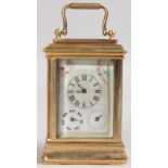 A MINIATURE BRASS CARRIAGE CLOCK with Sevres panels. 3ins high.