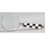 A MAGNIFYING GLASS with black and white handle.