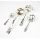 A group of four sterling silver ladles and spoons