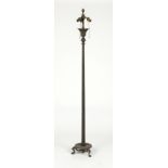 A patinated bronze floor lamp