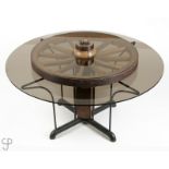 A smoked glass and wagon wheel kitchen table