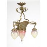 An Art Nouveau brass and glass ceiling fixture