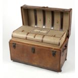 A vintage leather barrel-top steamer trunk