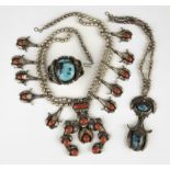 1040 A group of gem and silver Native American jewelry Stamped for Carl Luthy Shop, one coral