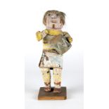 1041 A Hopi Kachina doll Early 20th century, Piptuka clown, depicted with blonde hair, carrying a