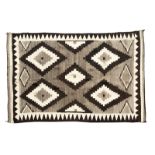 1045 A Navajo regional rug Second quarter 20th century, woven of brown, gray and cream wool, stepped