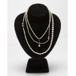 A group of three pearl necklaces