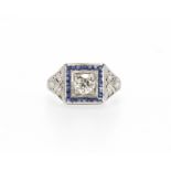 A late Art Deco diamond and blue stone ring