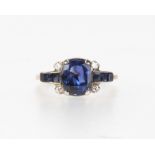 A cushion cut sapphire and diamond ring