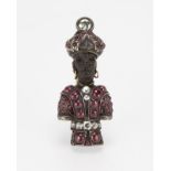 An antique ebony, ruby, diamond blackamoor brooch