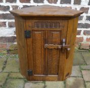Small oak corner cupboard with carved pa