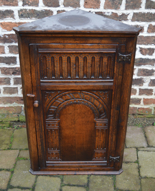 Ornately carved reproduction oak corner