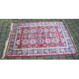 Red ground Kashmir rug with an Aztec des