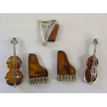 5 silver and amber brooches in the form