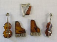 5 silver and amber brooches in the form